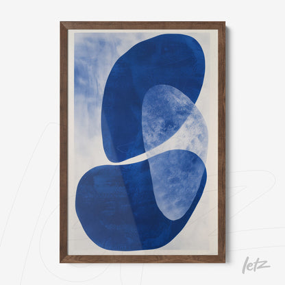 abstract wall art in shades of blue displayed in dark wood frame