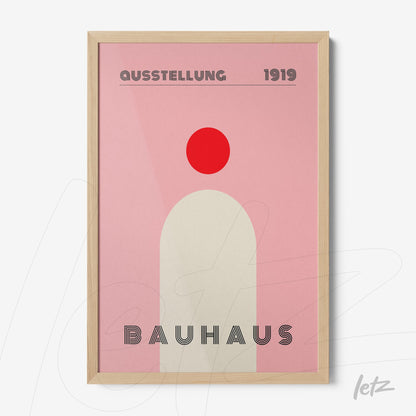 minimalist bauhaus style art print in light wooden frame featuring red circle on pink background