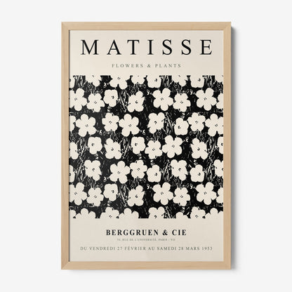 framed vintage style wall art featuring white flowers on black background with light wooden frame