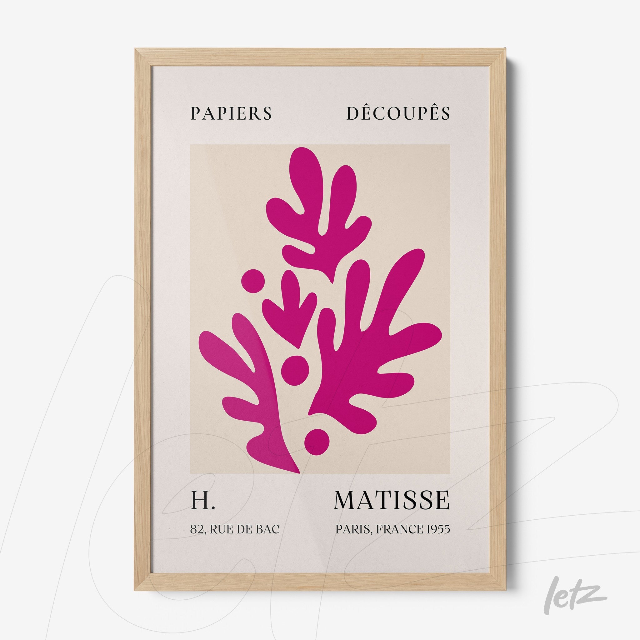 framed contemporary art piece in shades of pink on light background with light wood frame