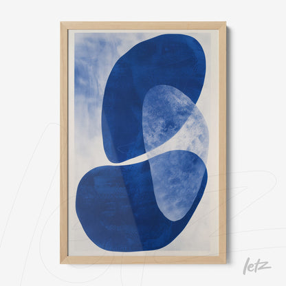 framed abstract wall art in shades of blue with light wood frame
