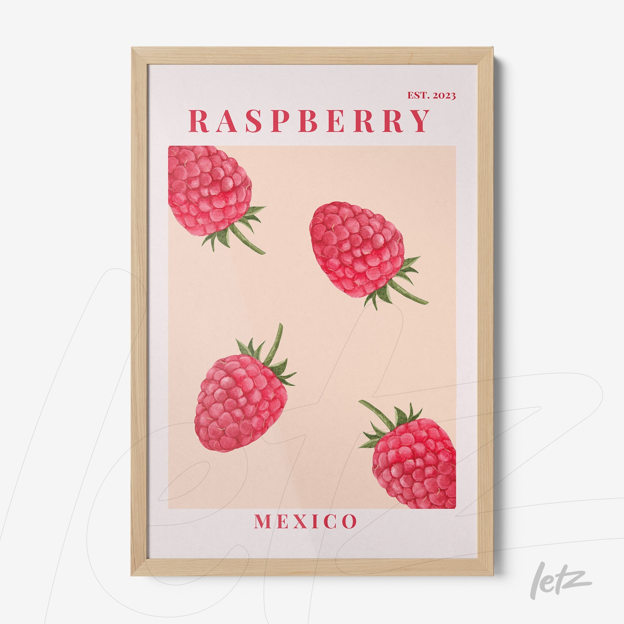 framed wall art featuring raspberries with a light wood frame and pink background