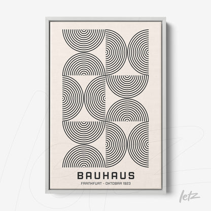 modern Bauhaus style poster with black concentric circles on a light background, displayed in a thin gray frame