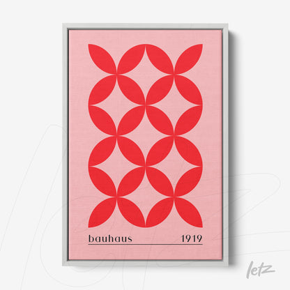 framed geometric art with repetitive red circles pattern on pink background, gray frame