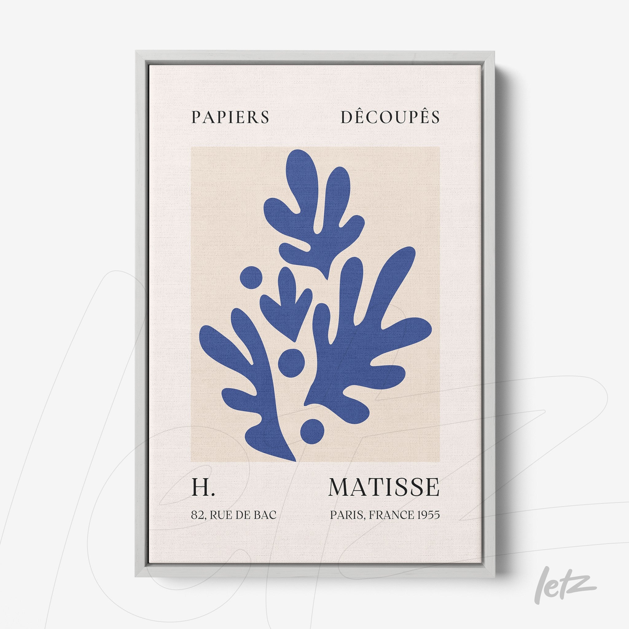 framed wall art featuring abstract blue leaves on a light background with silver frame