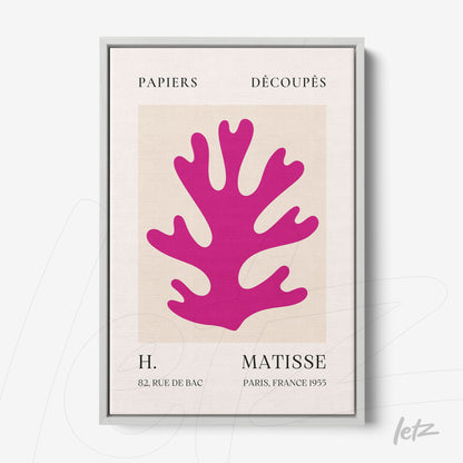 framed wall art featuring paper cutouts of a large pink coral on a light background with a silver frame