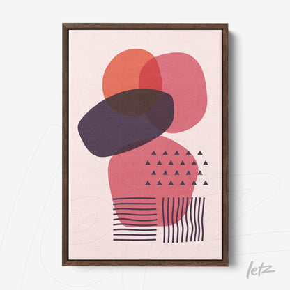 framed wall art of geometric abstract design in warm colors with dark wood frame displayed against white wall
