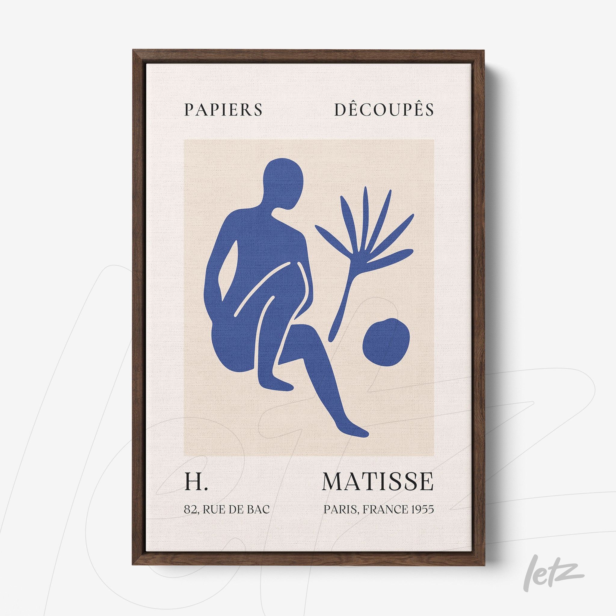 framed wall art featuring simplified blue shapes on beige background, dark wood frame