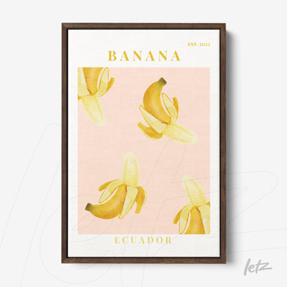 framed wall art featuring banana illustrations on a pink background with a dark wood frame