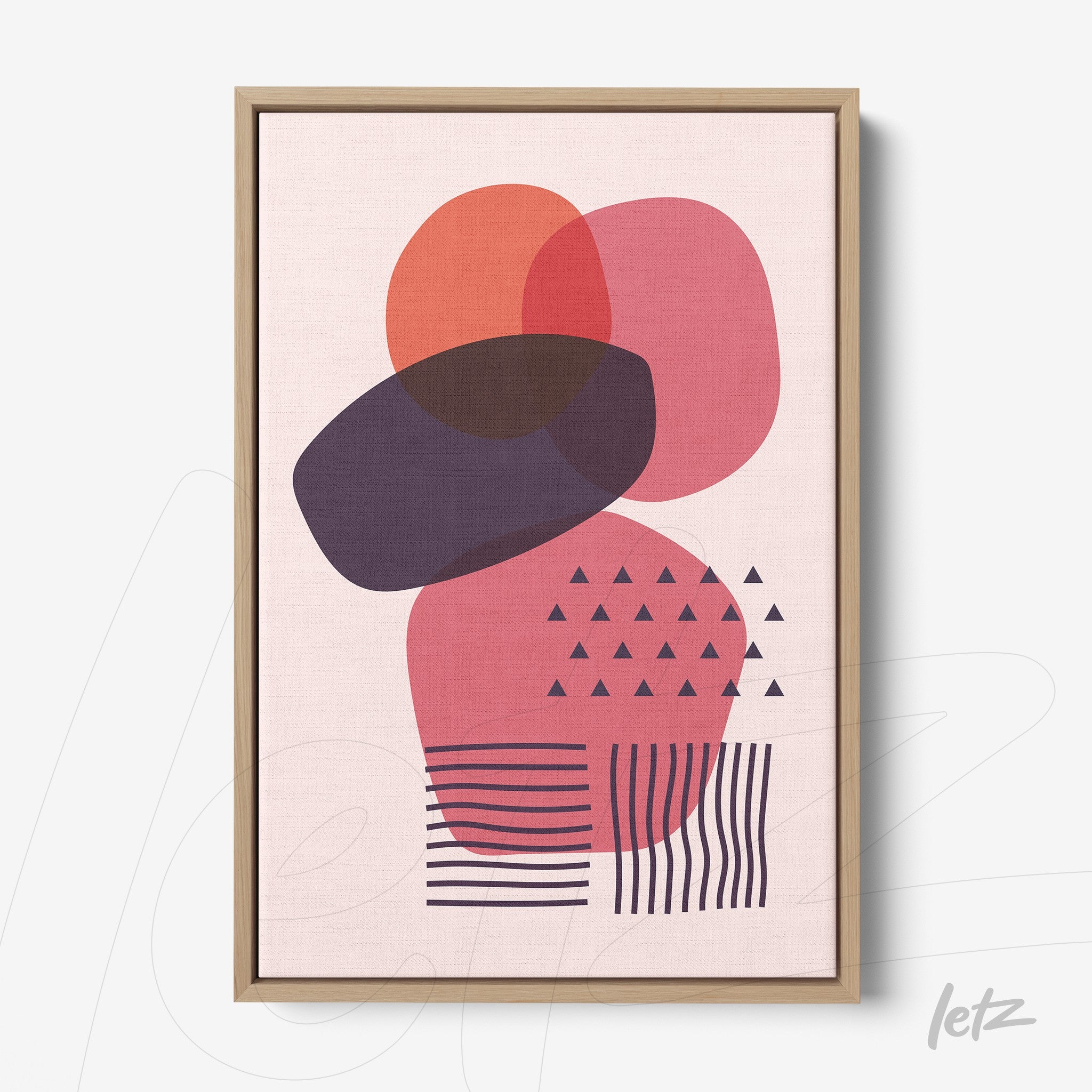 abstract geometric art in pink and purple tones with light wood frame