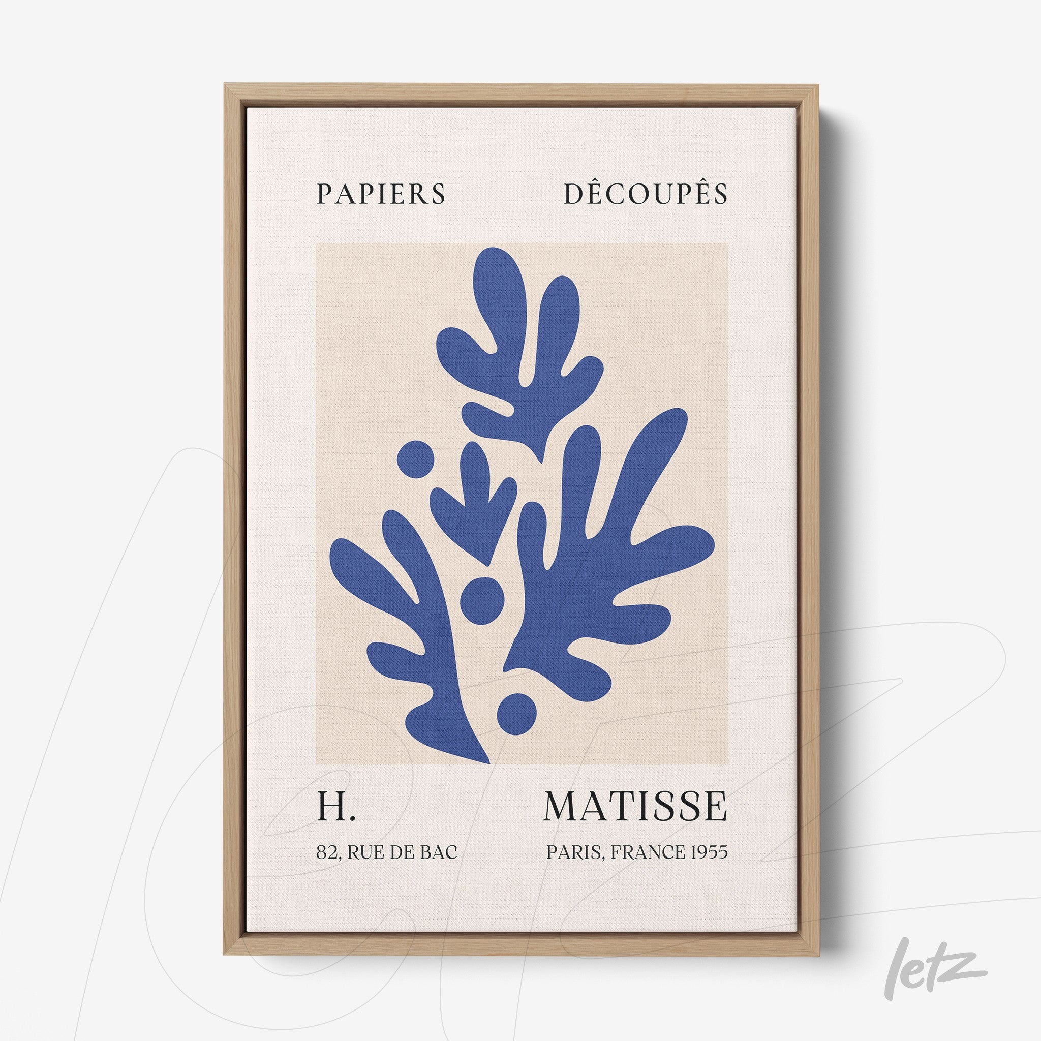 framed modern art featuring blue leaf shapes on textured background with light wood frame