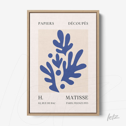 framed modern art featuring blue leaf shapes on textured background with light wood frame