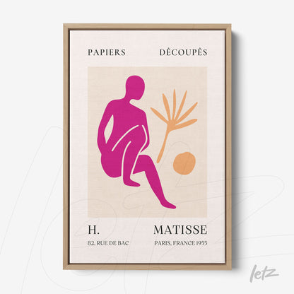 framed modern art depicting a female figure in pink tones with leaves and a ball on a light background