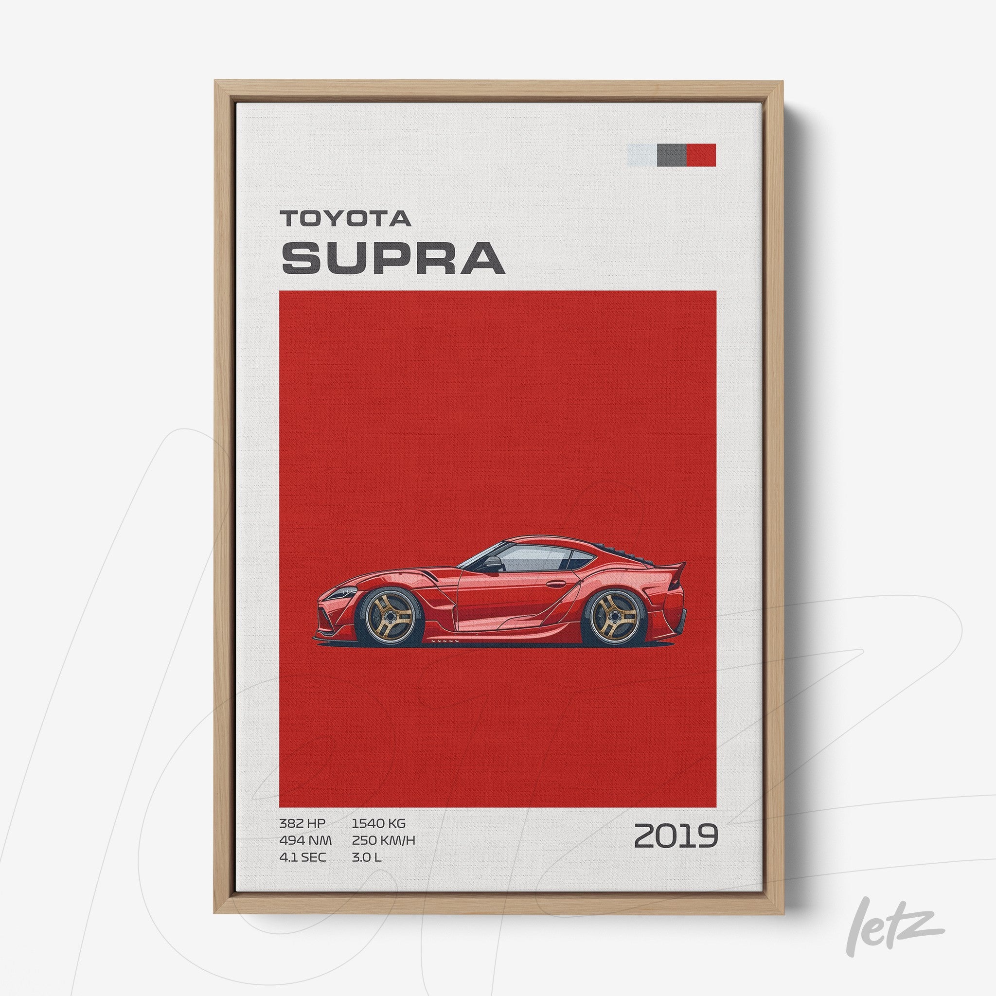 framed wall art featuring a red illustration of the Toyota Supra with a light wood frame