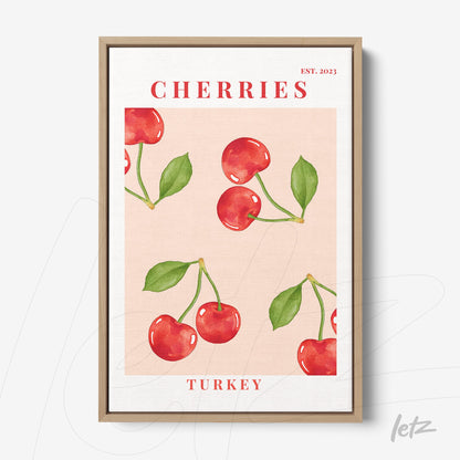 framed wall art featuring watercolor cherries on a light pink background with a light wood frame
