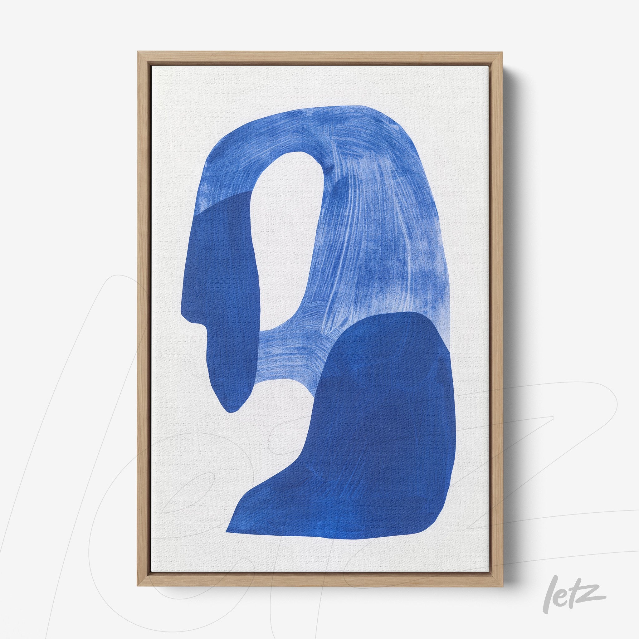 abstract wall art featuring blue shapes on a light background in a light wood frame