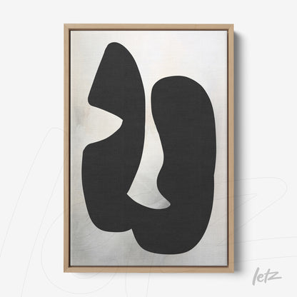 framed wall art featuring an abstract black composition on a light background with a light wood frame