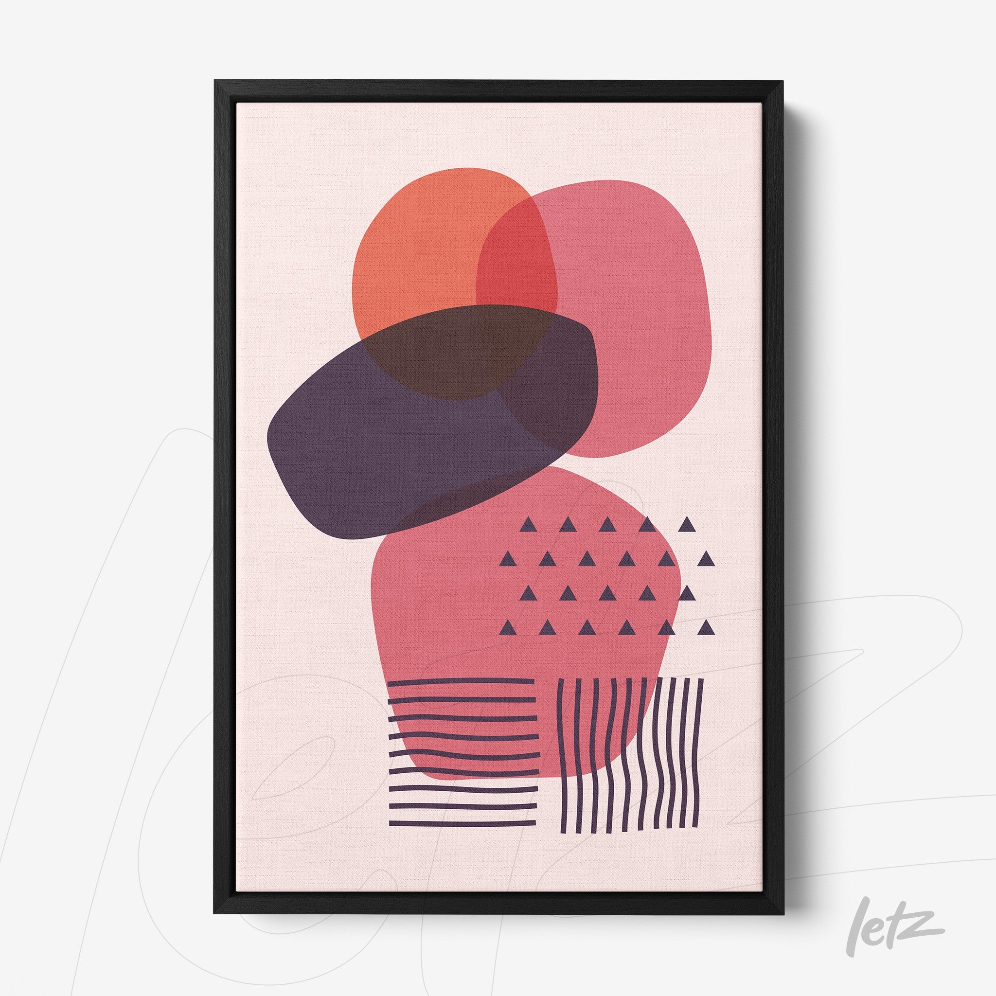 framed abstract geometric art in pink and lilac tones with black frame