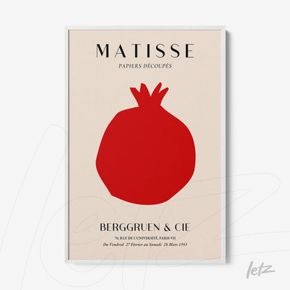 framed modern art featuring a red pomegranate silhouette on a cream background with a sleek white frame