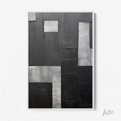 abstract wall art in black and white featuring textures in various shades of gray framed in white