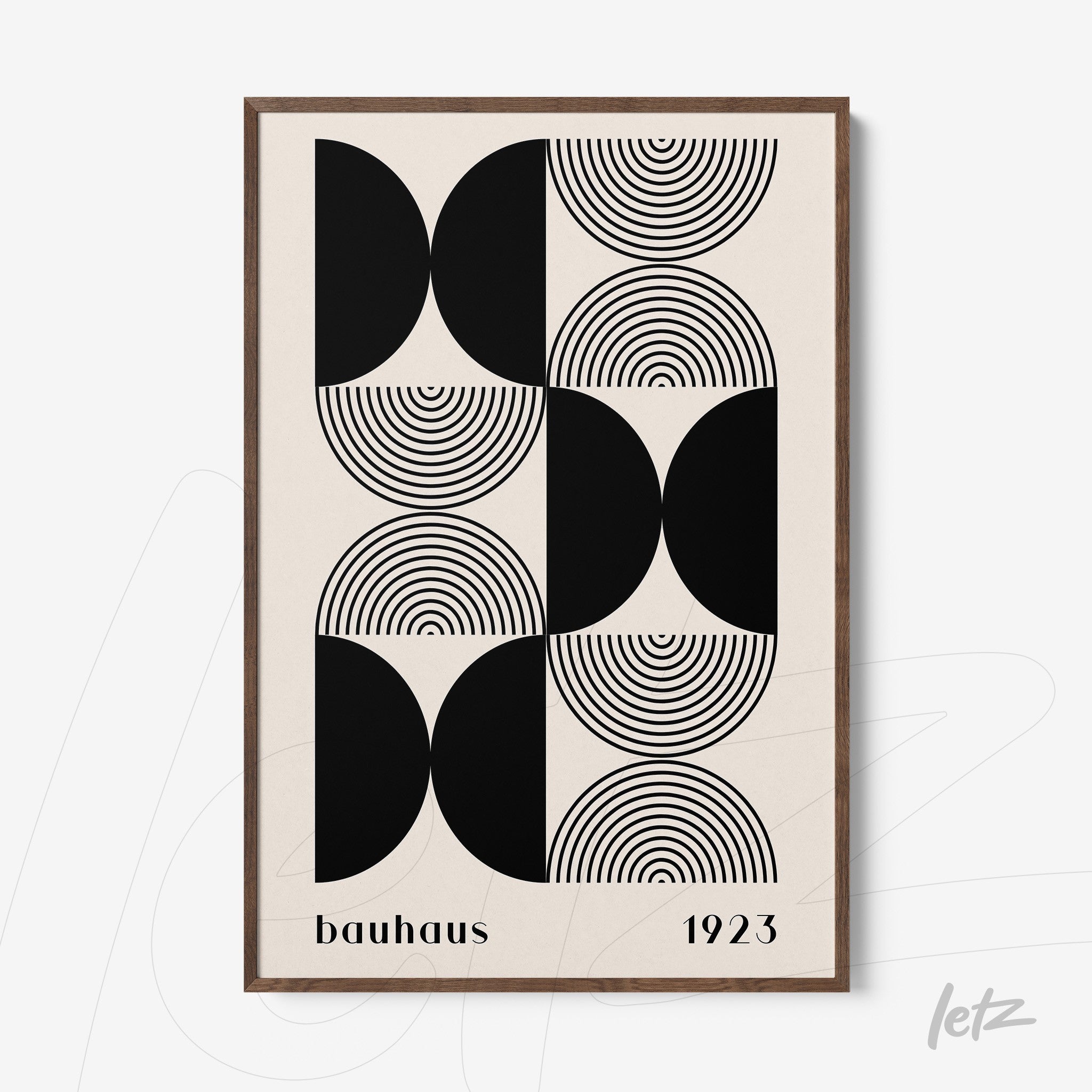 black and white geometric bauhaus style print in a dark wood frame