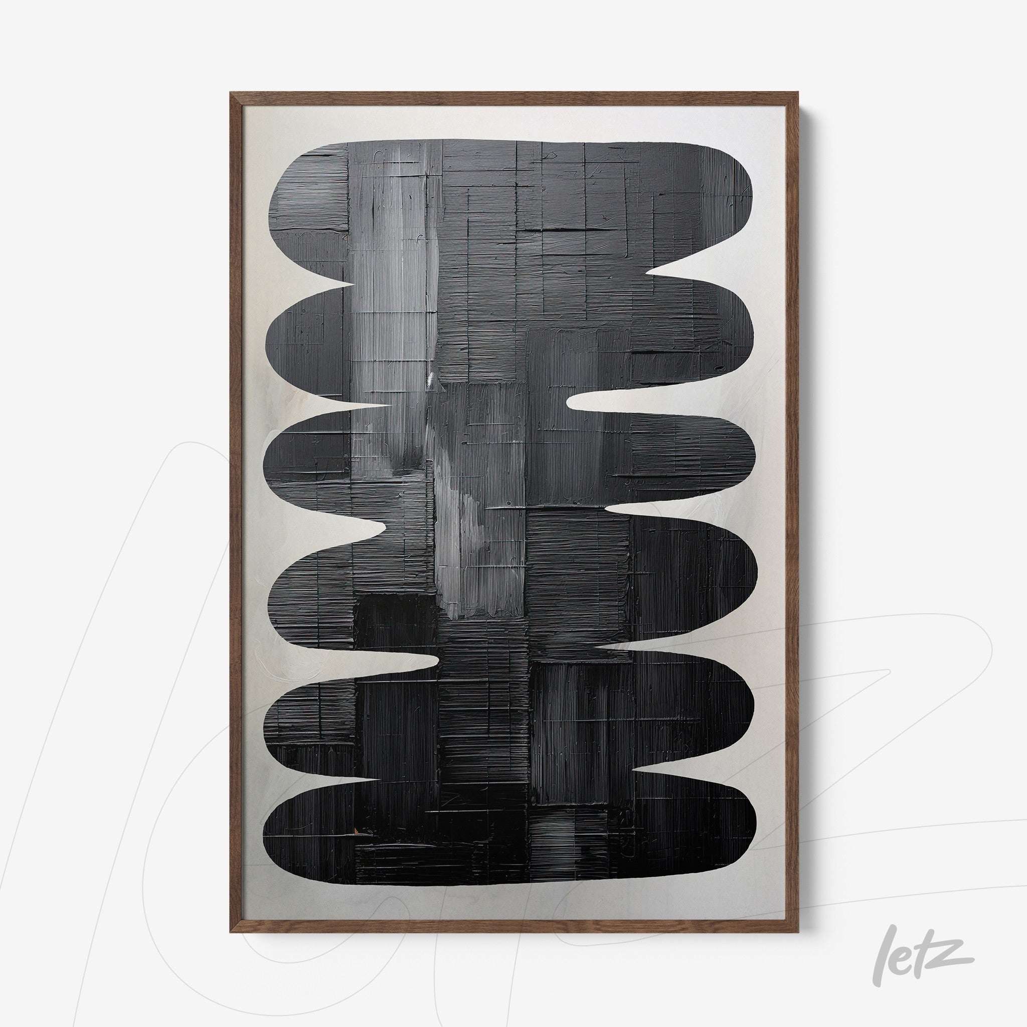 abstract wall art featuring black and white shapes in light wood frame