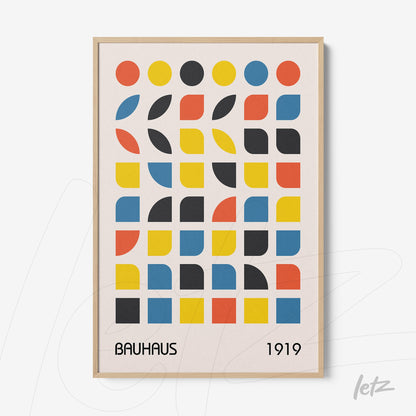 print featuring colorful geometric shapes in bauhaus style framed in light wood