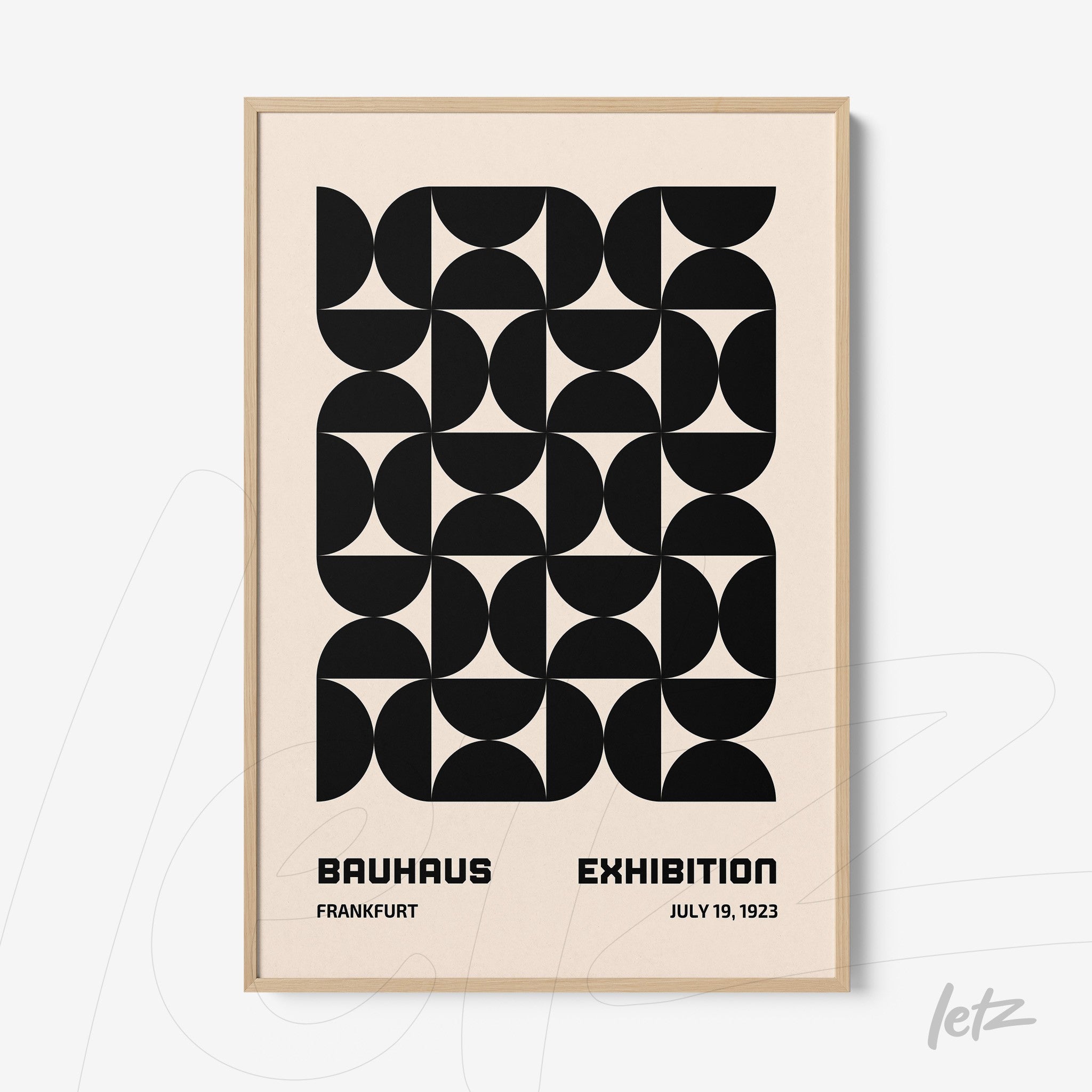 poster with black and white geometric art in a light wood frame, featuring text about the Bauhaus exhibition in 1923