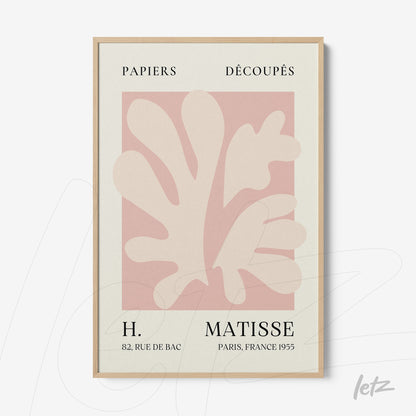 minimalist framed art featuring paper cutouts in soft coral colors with light wood frame