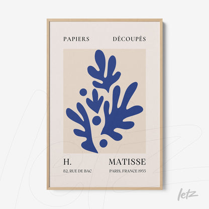 framed abstract artwork in blue on light background, featuring light wood frame and French text