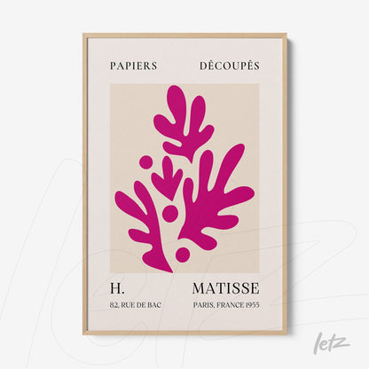 framed wall art featuring cut paper design in vibrant red with light wood frame