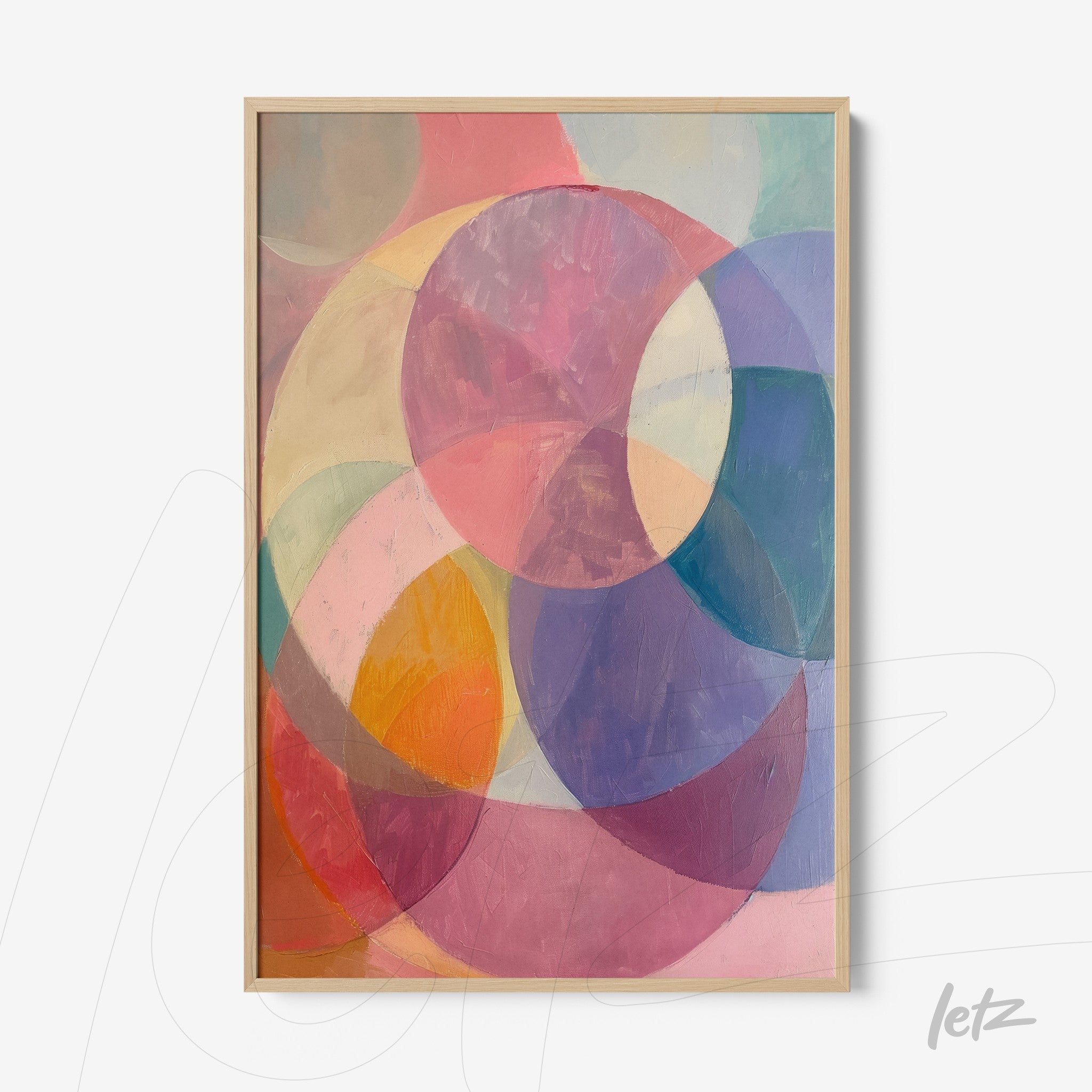 abstract wall art featuring circular shapes in pastel colors, framed in light wood