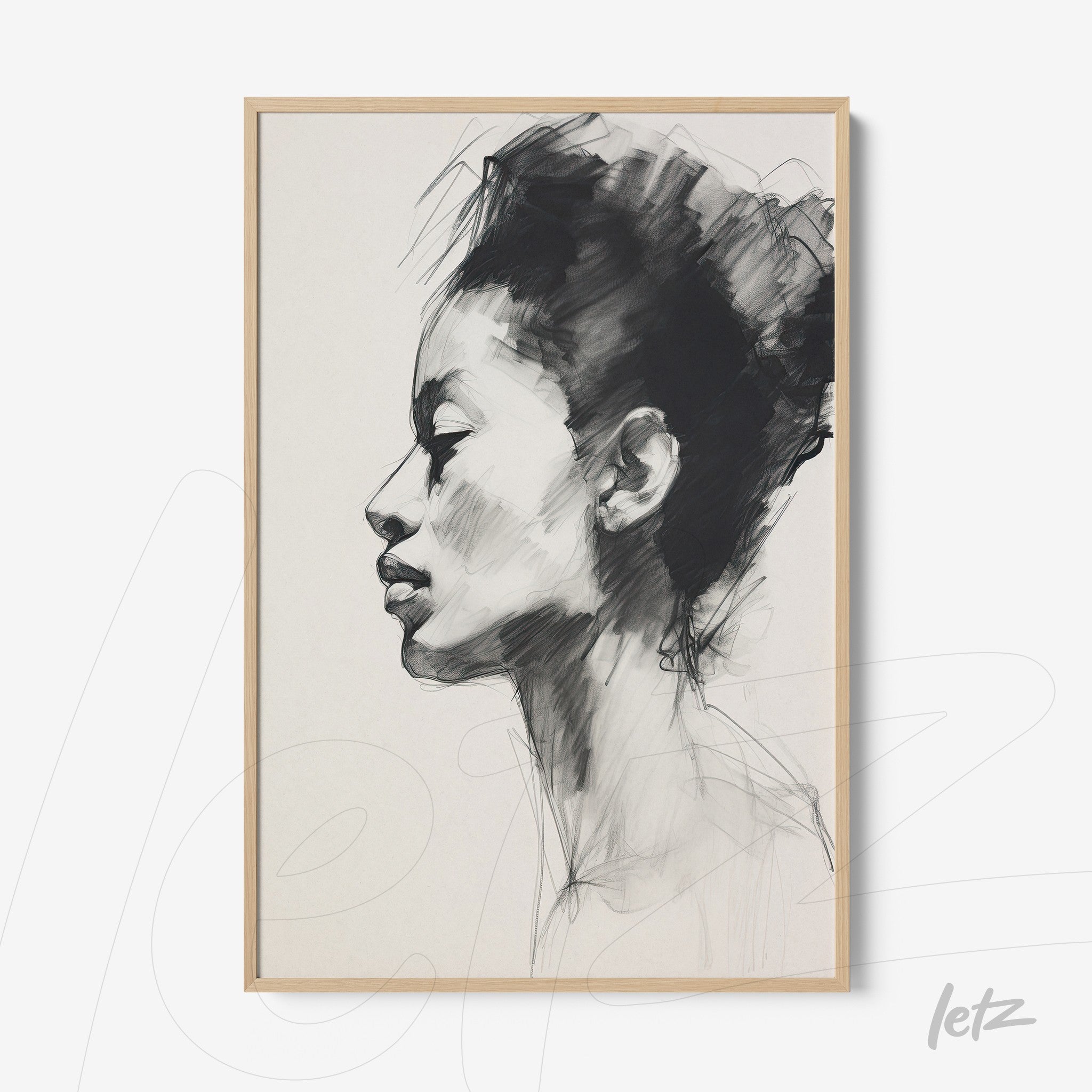 framed black and white portrait of a woman in profile with light wood frame