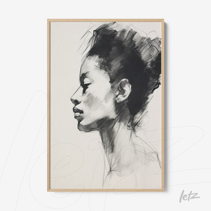 framed black and white portrait of a woman in profile with light wood frame