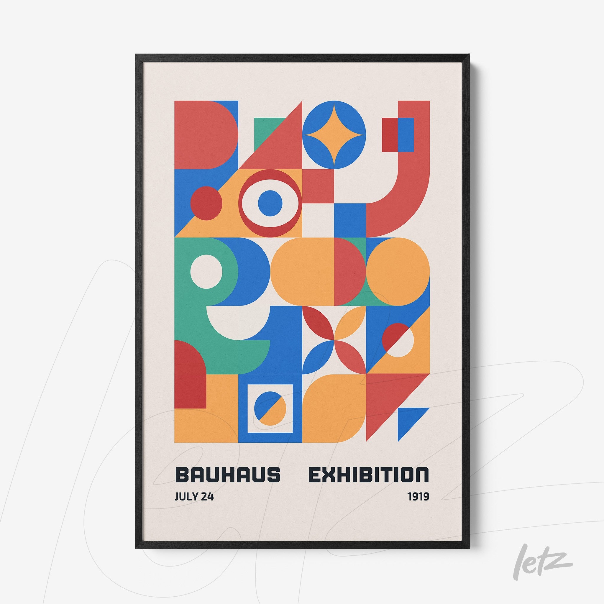 colorful geometric poster art in black frame displayed on a light wall