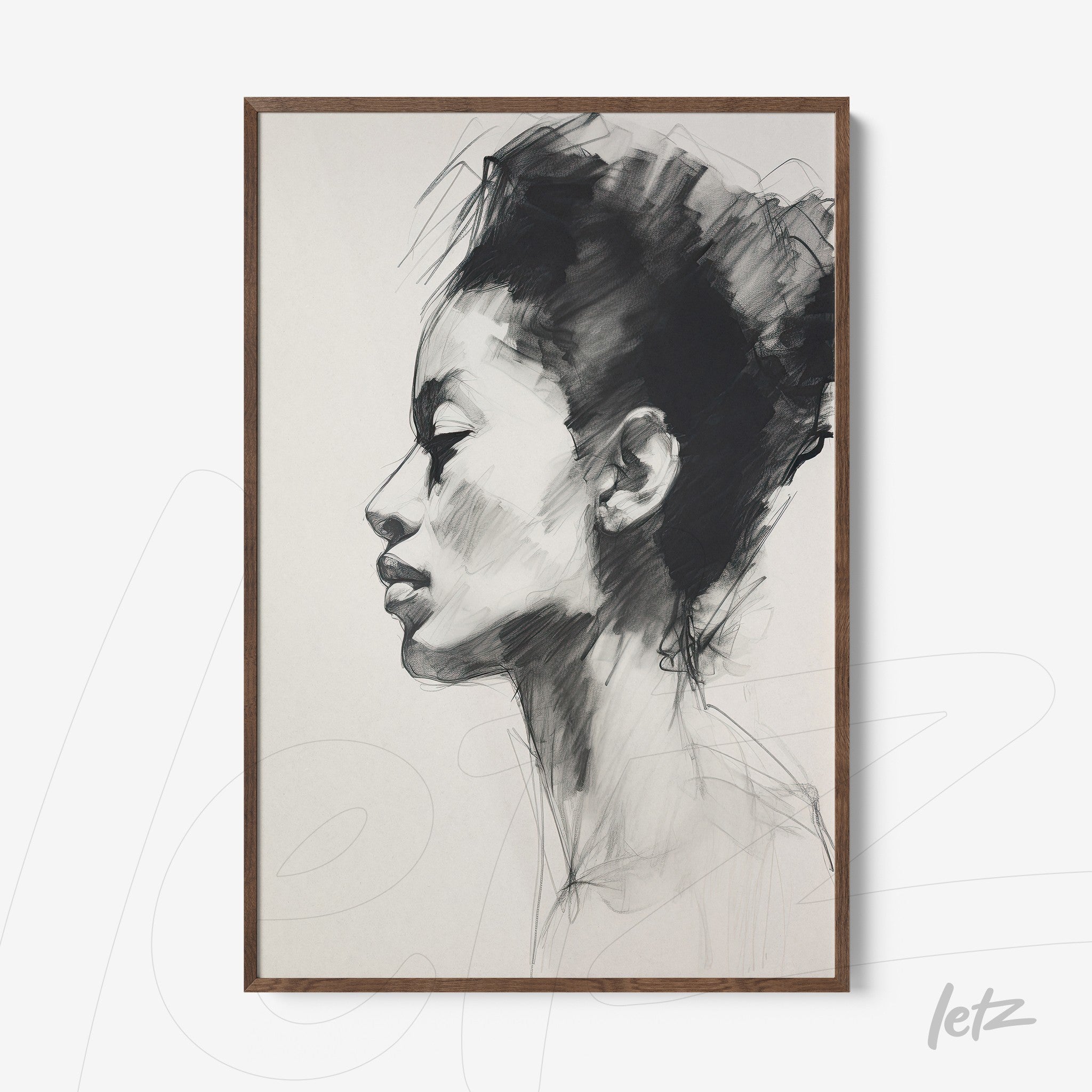 framed black and white artwork of a female profile in light wood frame