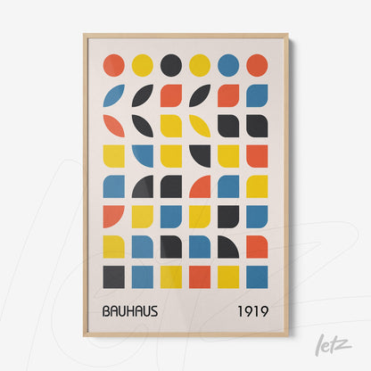 framed geometric Bauhaus-inspired art showcasing colorful shapes with a light wood frame