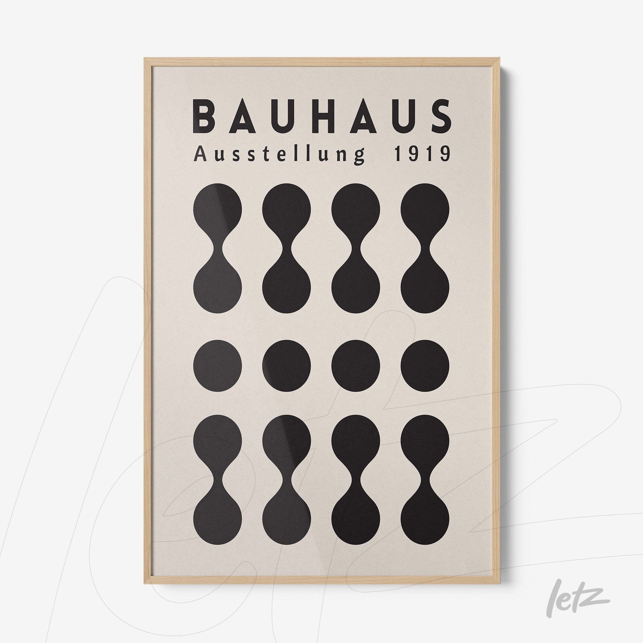 poster featuring Bauhaus style graphic design with black geometric shapes and text in a wooden frame