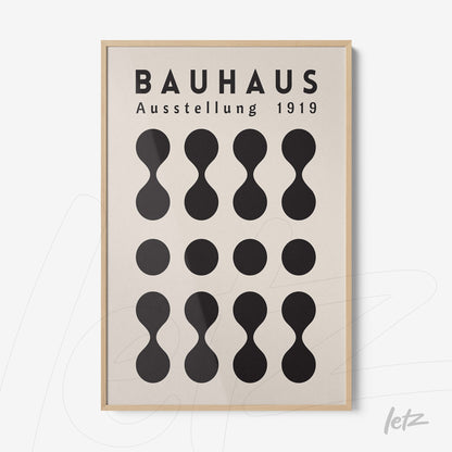 poster featuring Bauhaus style graphic design with black geometric shapes and text in a wooden frame