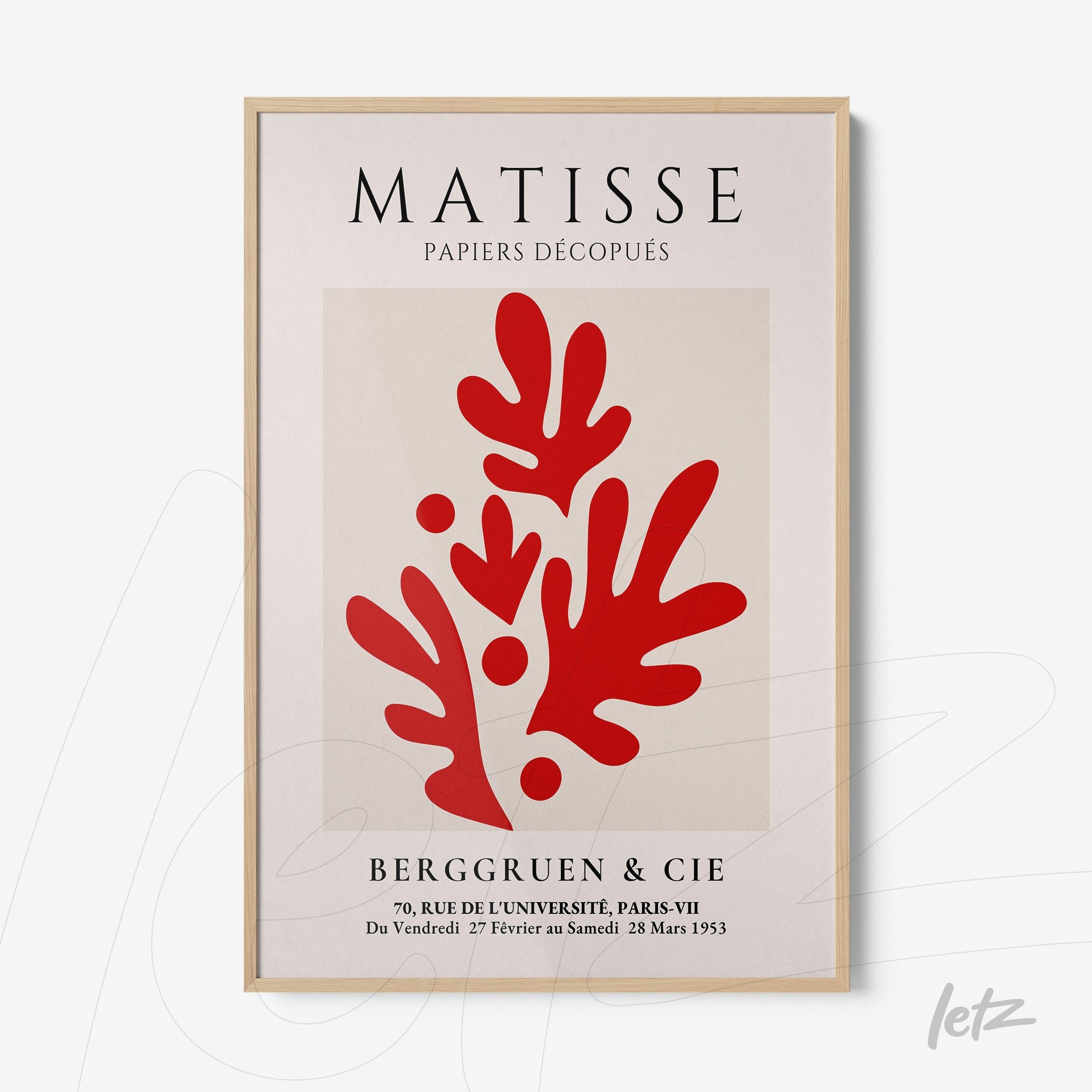 modern art print in shades of red on light background with light wood frame