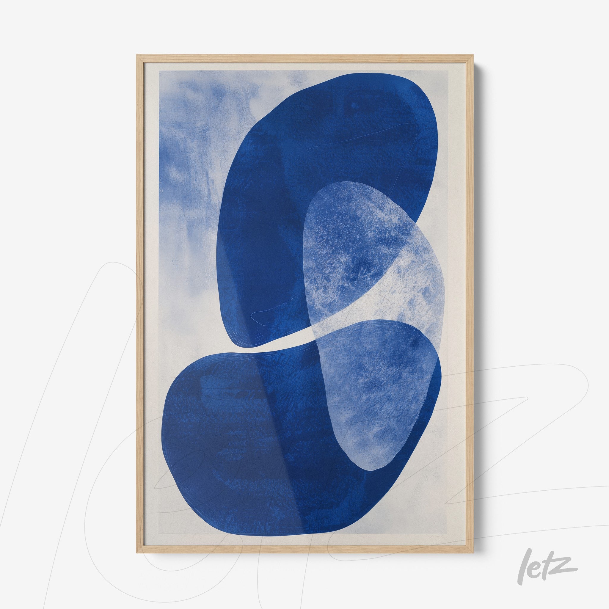 framed artwork featuring abstract shapes in blue tones against a light background with a light wood frame