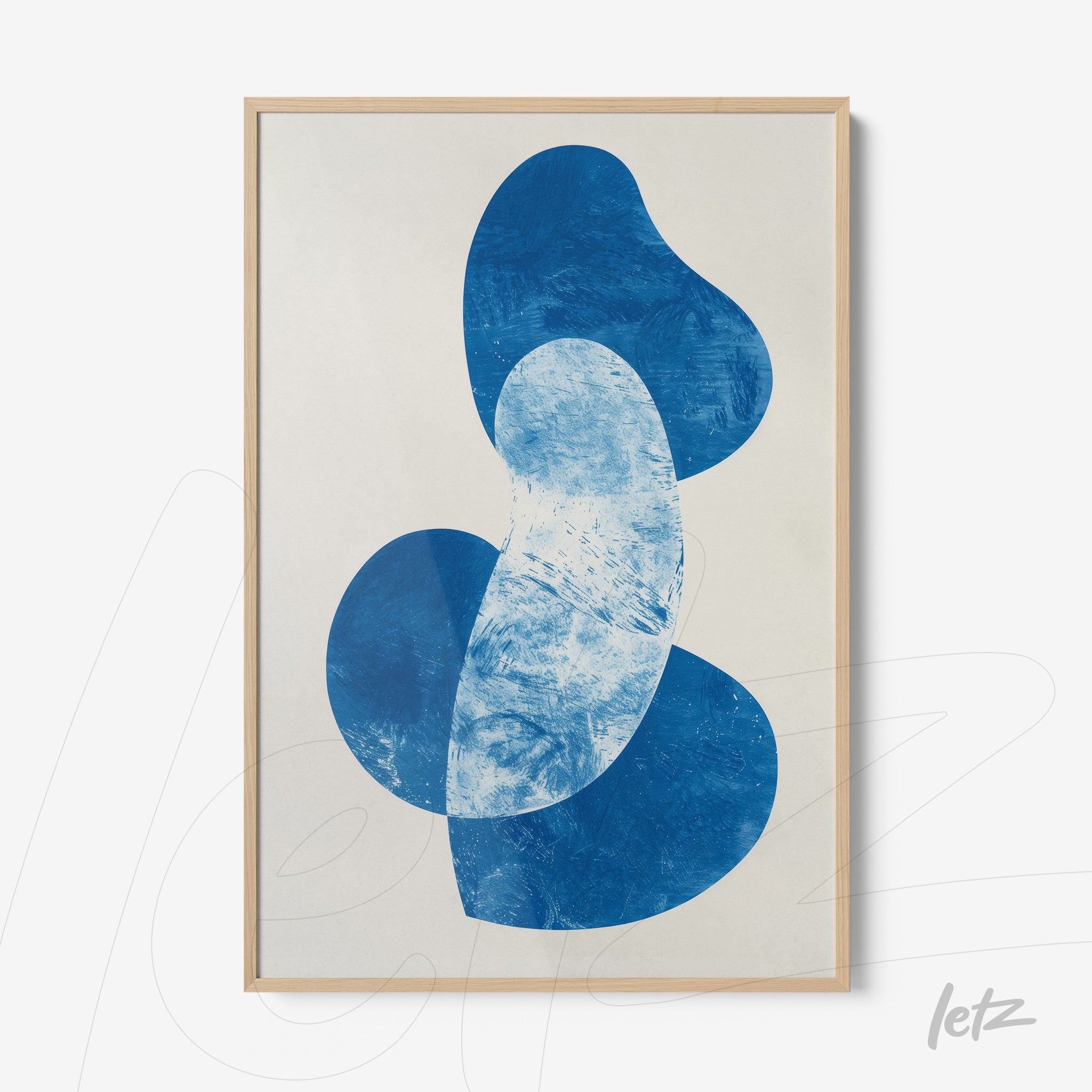 framed wall art featuring abstract shapes in shades of blue on a light background with a light wood frame