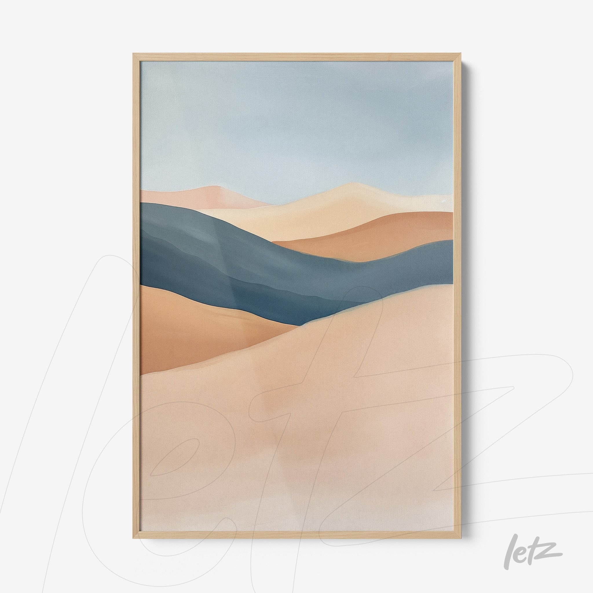 framed abstract art in earthy tones and blues with light wood frame
